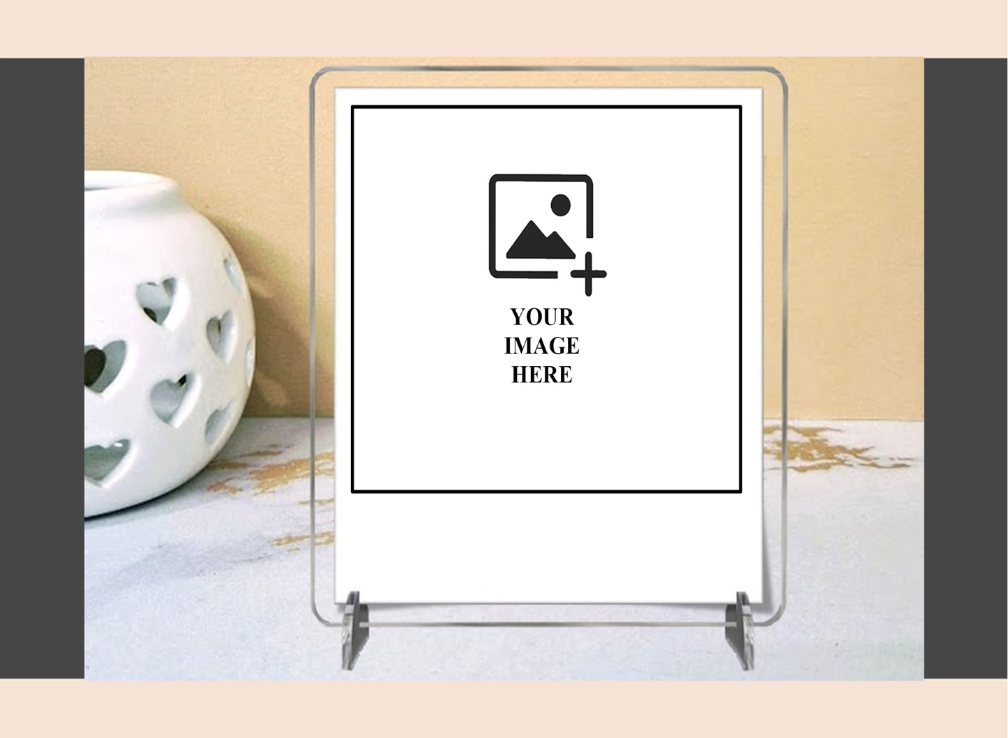 Clear acrylic photo frame on a decorative surface with a heart-patterned candle.