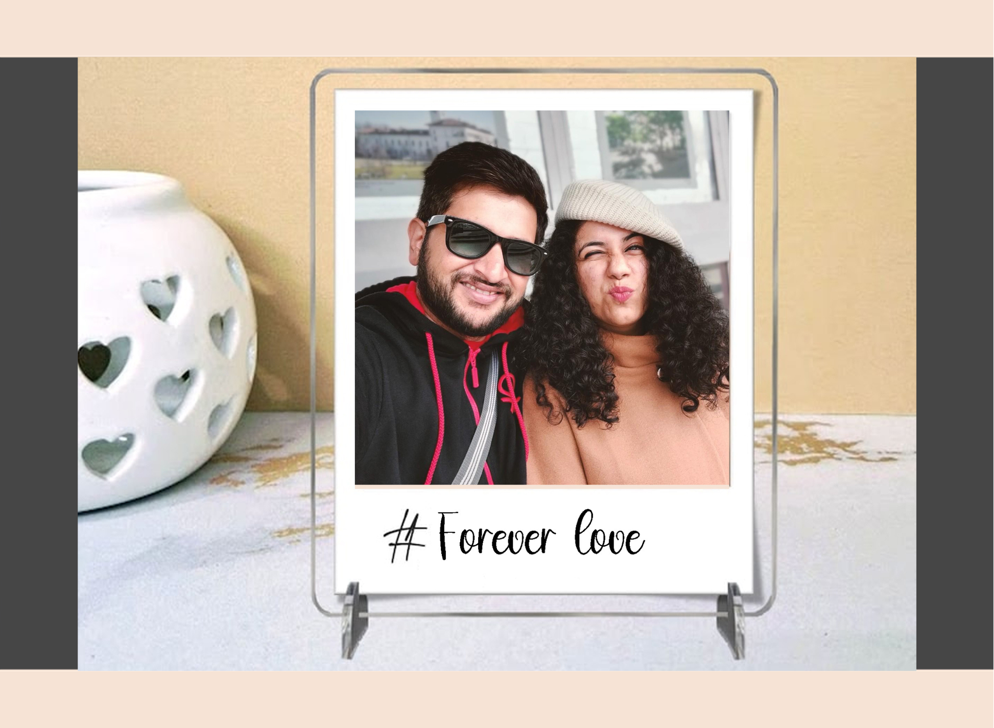 Polaroid frame with a photo of a couple and '#Forever Love' text on a decorative surface.