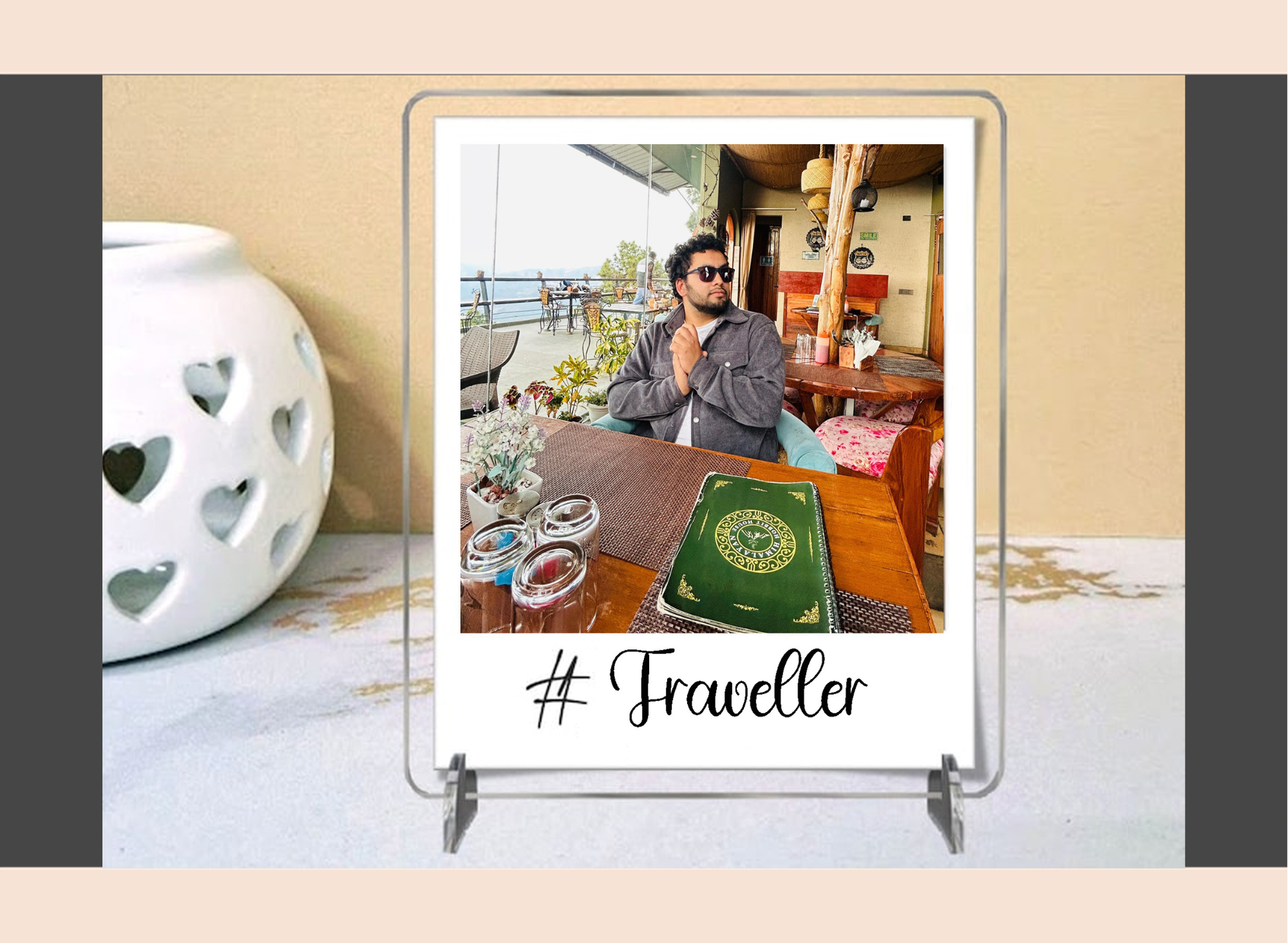 Polaroid with a photo of a person on a balcony and '#Traveller' text