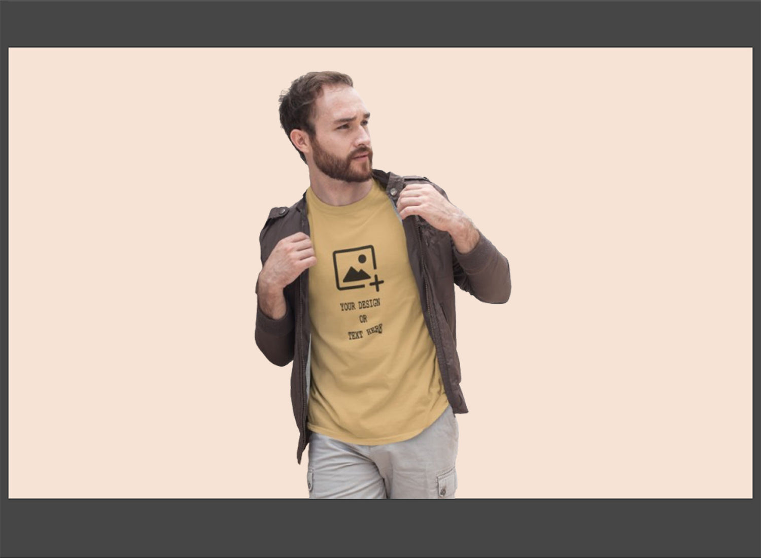 Man wearing a beige t-shirt with a graphic design on a beige background