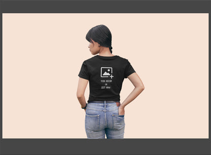 Person wearing a black t-shirt with a design on back.