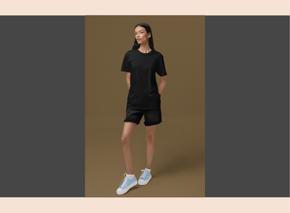 Person wearing a black outfit with white sneakers on a brown background