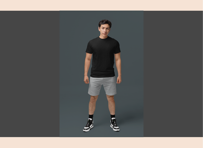 Man wearing a black t-shirt and gray shorts on a gray background