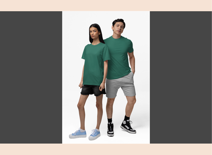 Two people wearing green t-shirts and gray shorts on a white background