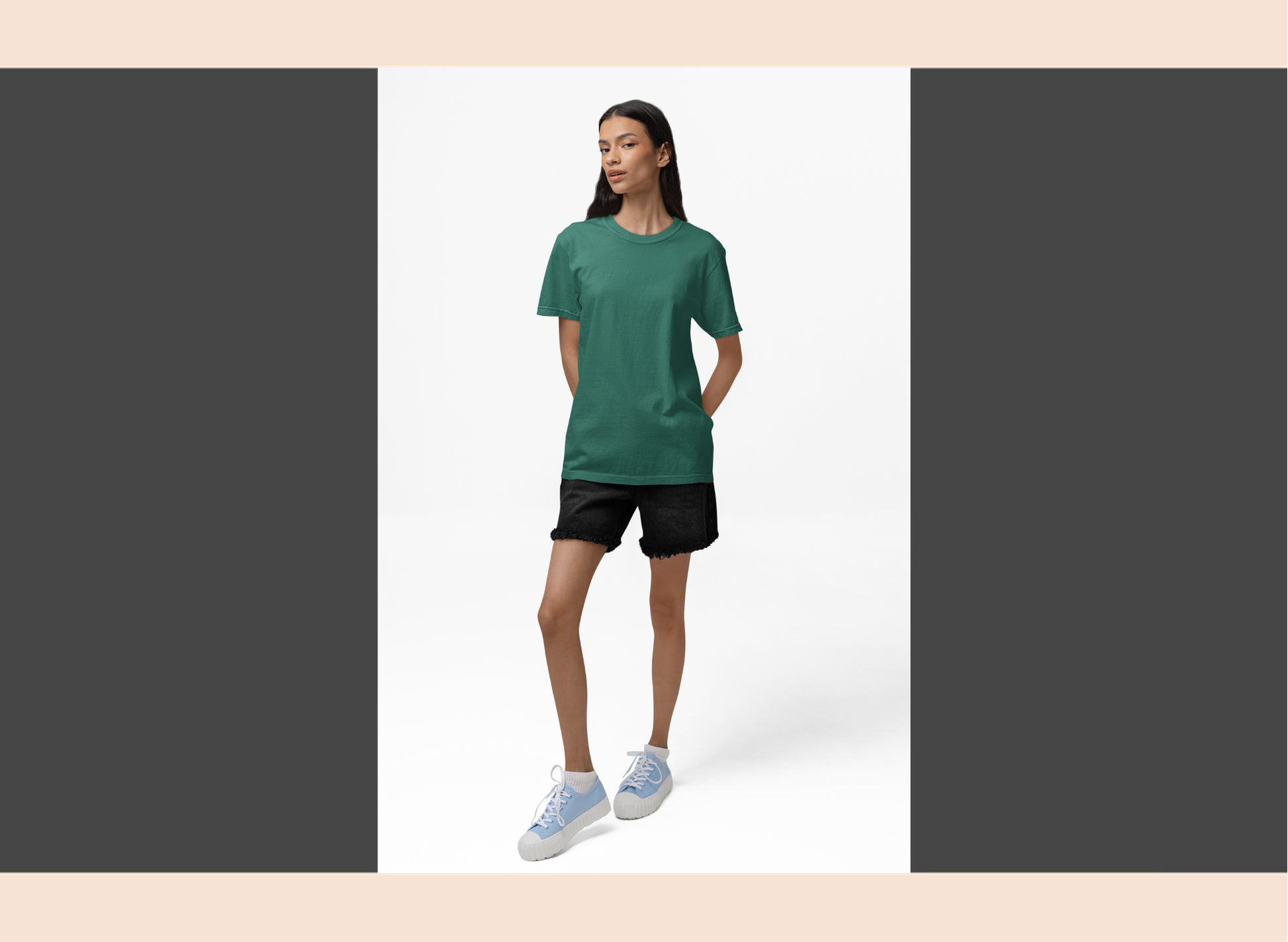 Woman wearing a green t-shirt and black shorts on a white background