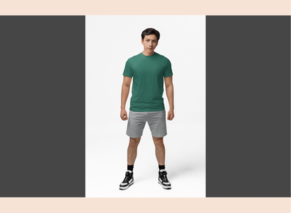 Man wearing a green t-shirt and gray shorts on a white background