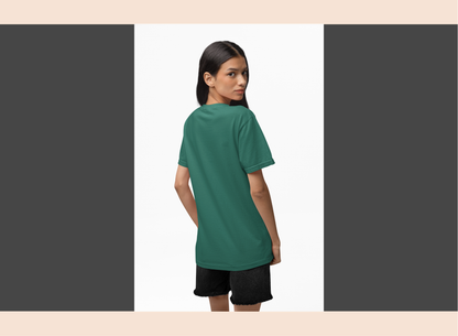 Woman wearing a green t-shirt and black shorts on a white background