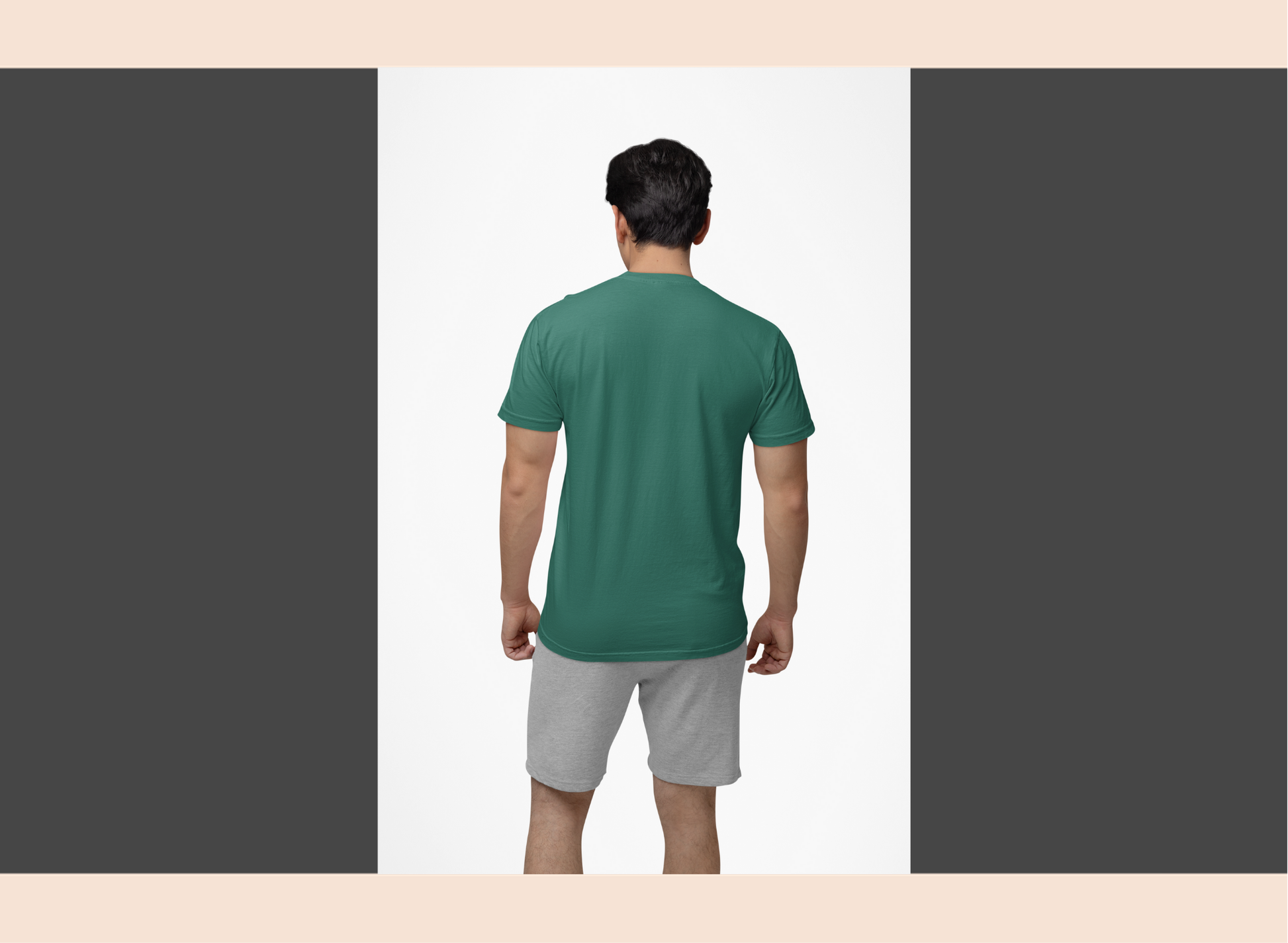 Man wearing a green t-shirt and gray shorts on a white background