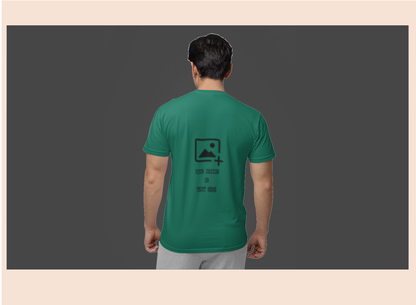 Person wearing a green t-shirt with a logo on the back against a dark background