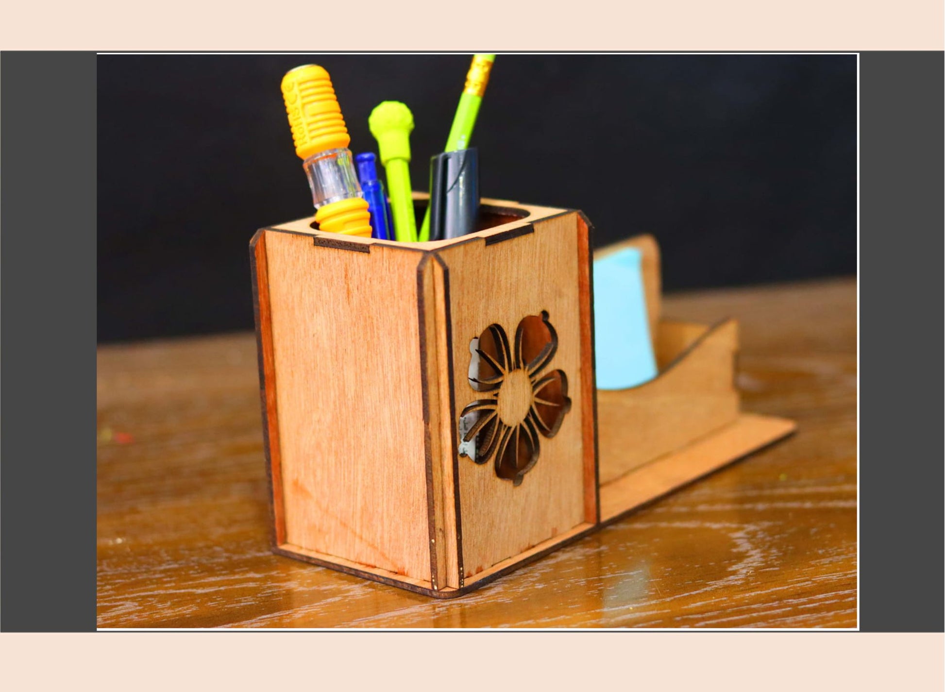 Wooden pen holder with colorful pens on a wooden surface