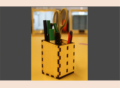 Wooden pencil holder with stationery items on a blurred background