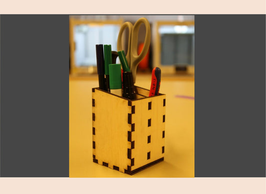 Wooden pencil holder with stationery items on a blurred background