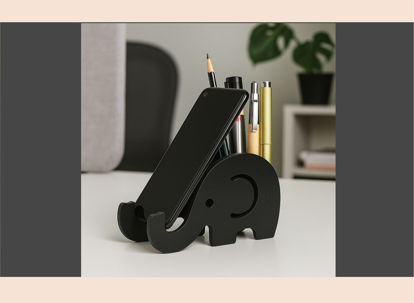 Black elephant-shaped phone stand on a desk with office supplies.