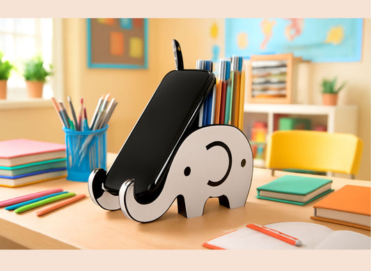 Black and white elephant-shaped pencil holder on a desk with stationery items