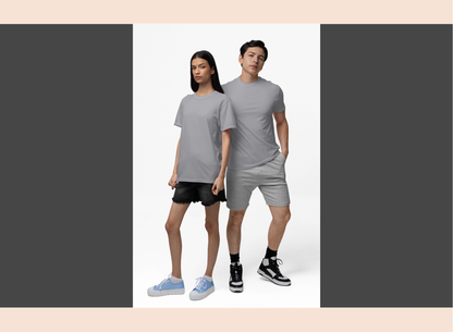 Two people wearing matching gray outfits on a plain background