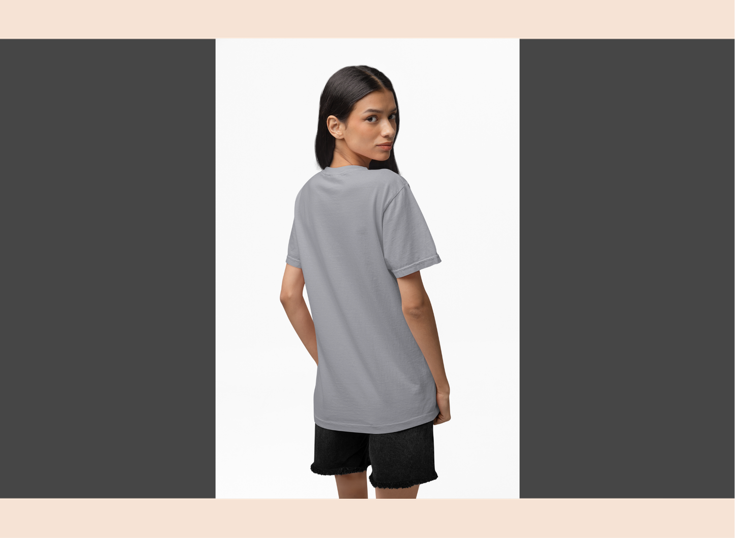 Woman wearing a gray t-shirt and black shorts on a white background