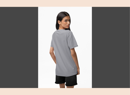 Woman wearing a gray t-shirt and black shorts on a white background