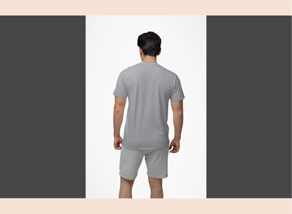 Man wearing a gray t-shirt and shorts set on a plain background