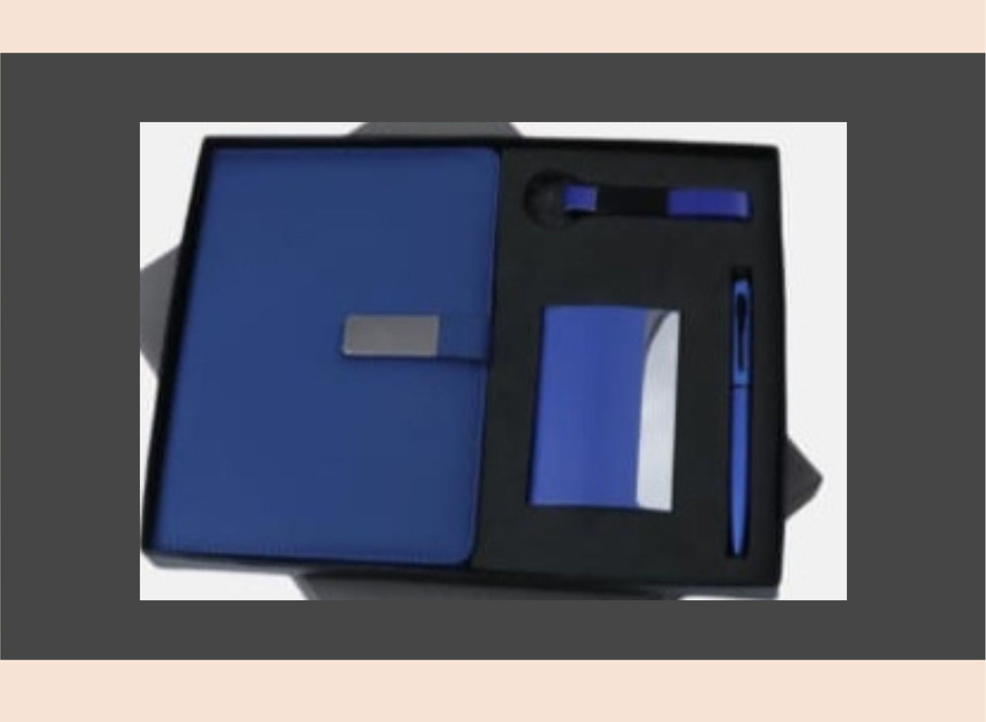 Blue notebook and pen set in a black box on a white background