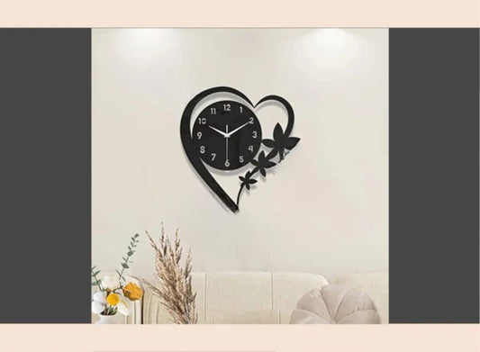 Heart-shaped wall clock with floral design on a light wall.