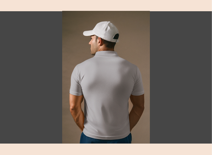 Man wearing a light gray polo shirt and white cap against a beige background
