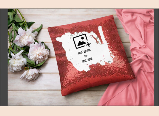Red sequin pillow with customizable design area on a wooden surface with flowers and fabric.