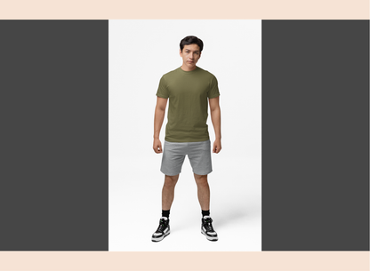 Man wearing a green t-shirt and gray shorts standing against a white background
