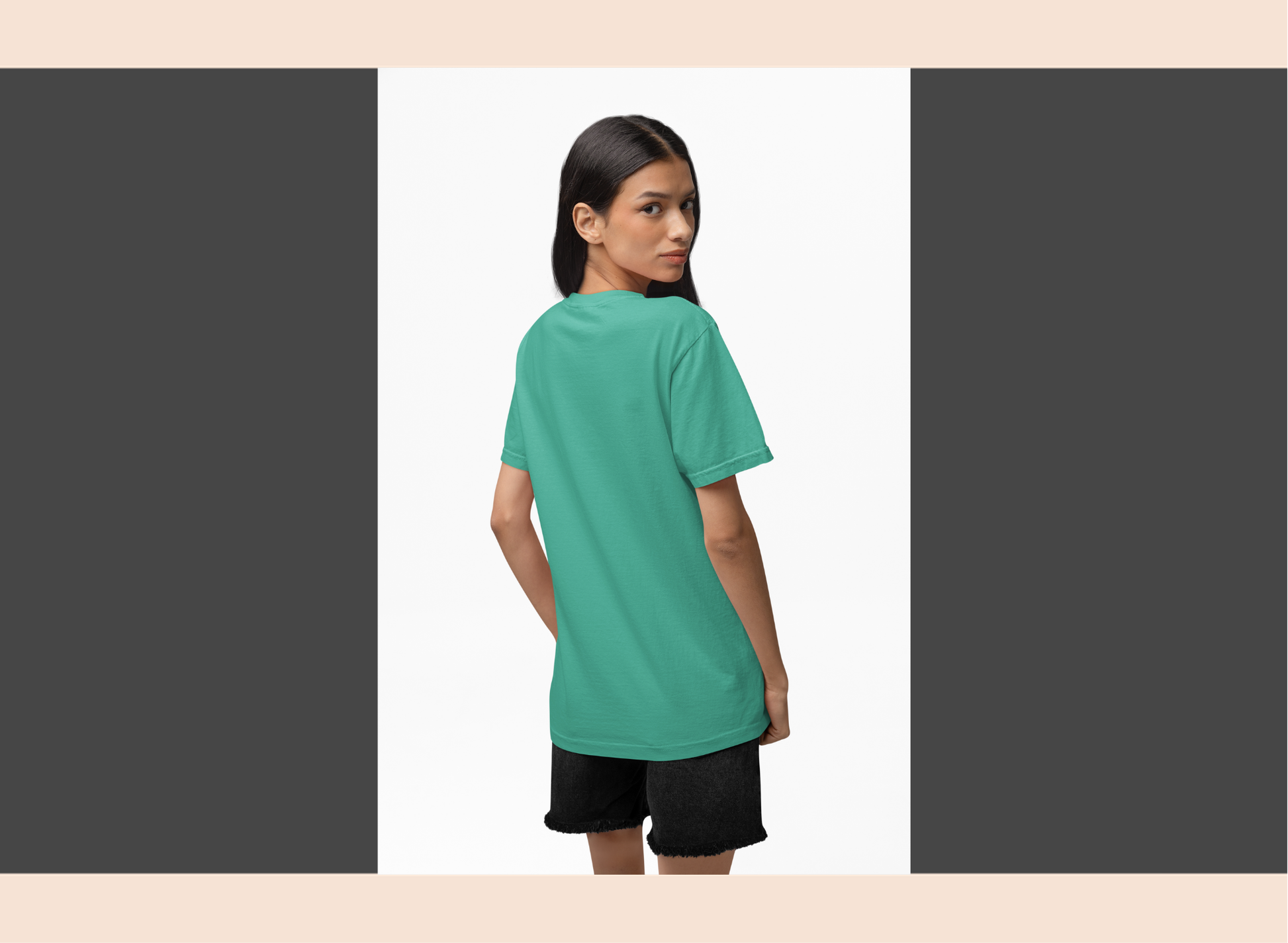 Woman wearing a teal t-shirt and black shorts on a white background