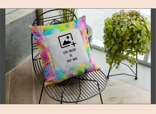 Colorful tie-dye pillow with a customizable design area on a black wire chair.