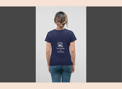 Person wearing a navy blue t-shirt with a design and text on the back, standing against a plain background.