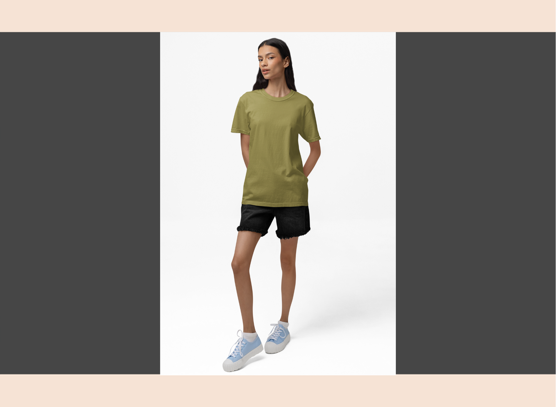 Person wearing a green t-shirt and black shorts on a white background