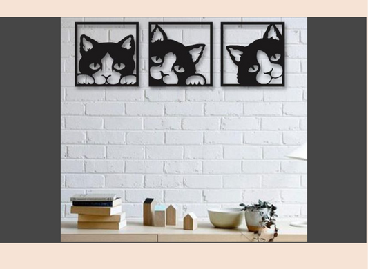 Three framed black and white cat portraits on a white brick wall above a wooden shelf.