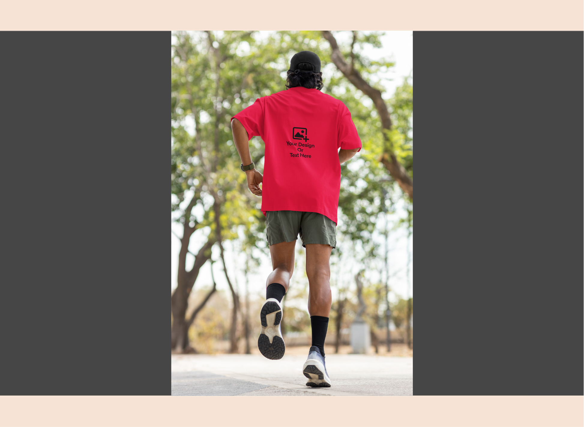 Person running outdoors wearing a red t-shirt with a logo