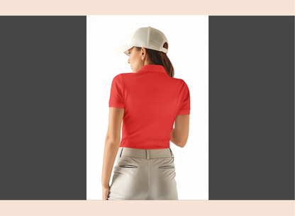 Woman in a red shirt and white pants standing on a golf course with a golf cart in the background.
