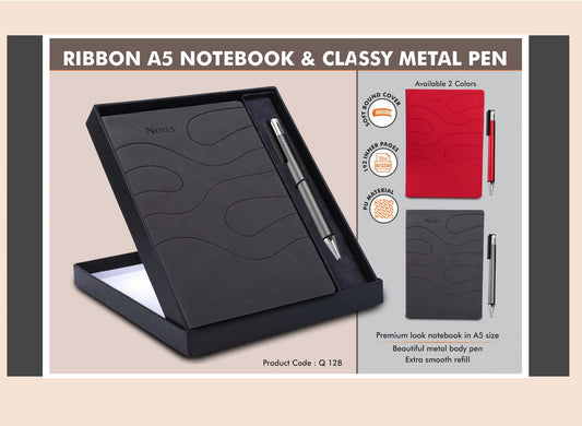 Ribbon A5 notebook and classy metal pen set with black notebook and silver pen in a box on a beige background.