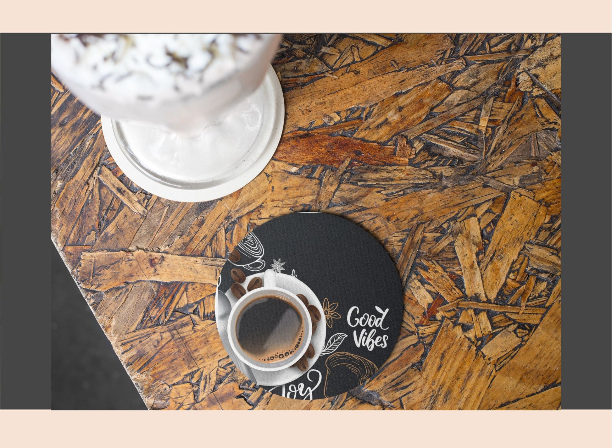 Coaster with 'Good Vibes' design on a wooden surface with a cup of coffee.