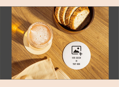 Glass of coffee and bread on a wooden table with a customizable coaster.