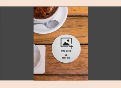 Personalized coaster with customizable text on a wooden table with a cup of coffee.