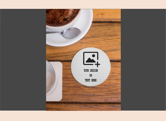 Personalized coaster with customizable text on a wooden table with a cup of coffee.