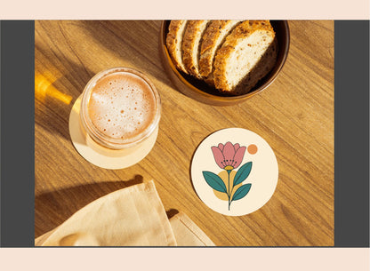 Cup of coffee with a floral coaster on a wooden table