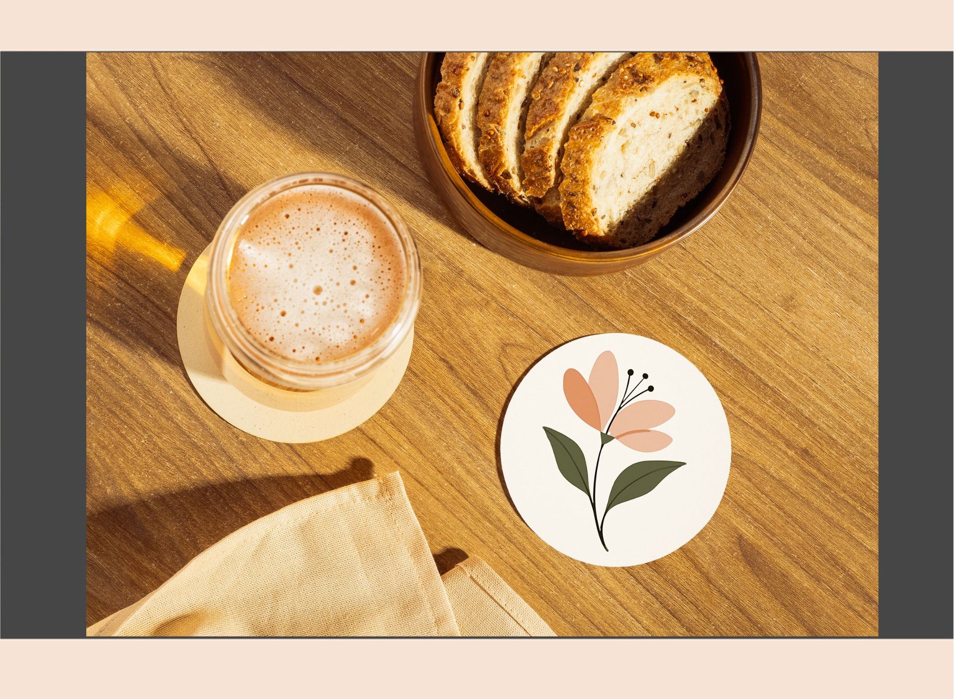 Cup of coffee with a bowl of bread on a wooden table, featuring a floral coaster.