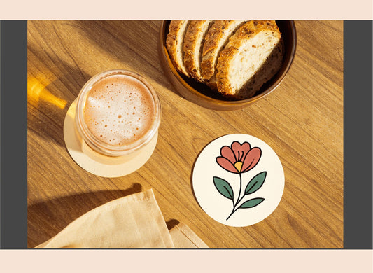 Glass of coffee, bowl of bread, and floral coaster on a wooden table