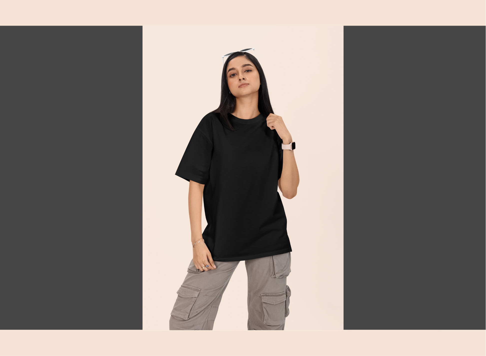 Person wearing a black t-shirt and gray cargo pants on a beige background
