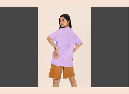 Woman wearing a light purple top and brown shorts on a beige background