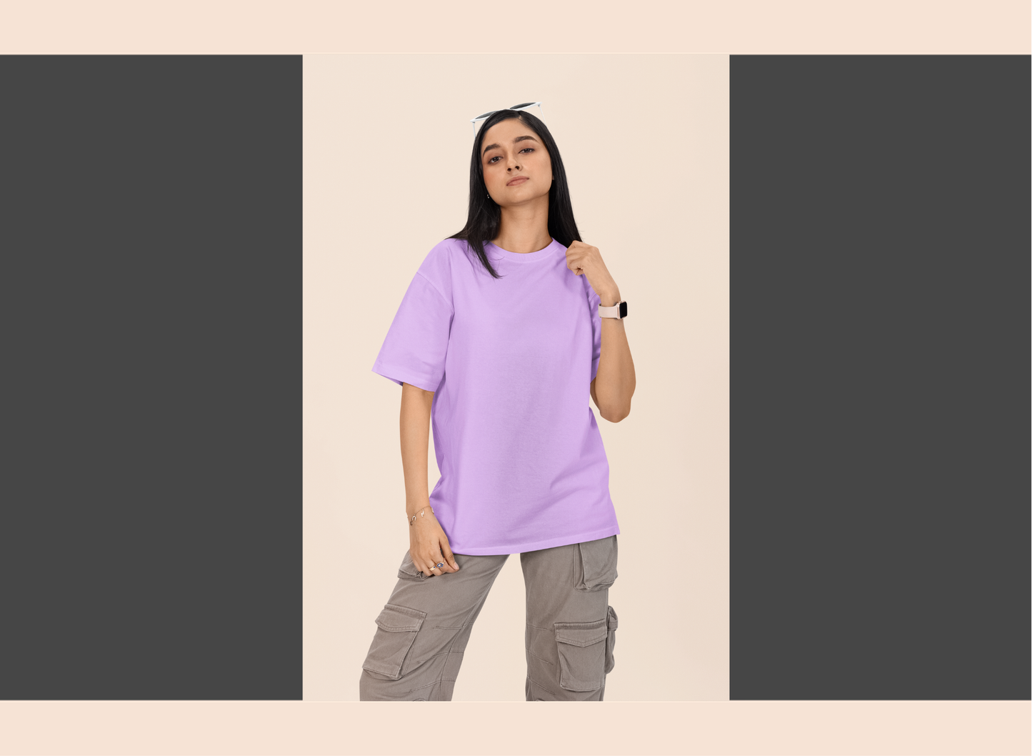Person wearing a light purple t-shirt and gray cargo pants on a beige background