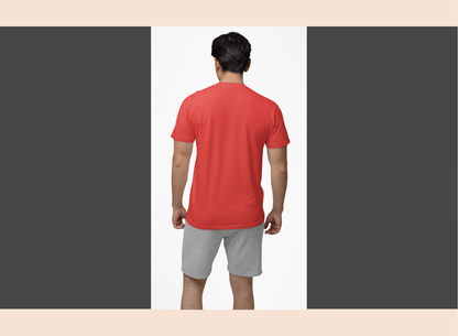 Man wearing a red shirt and gray shorts on a plain background