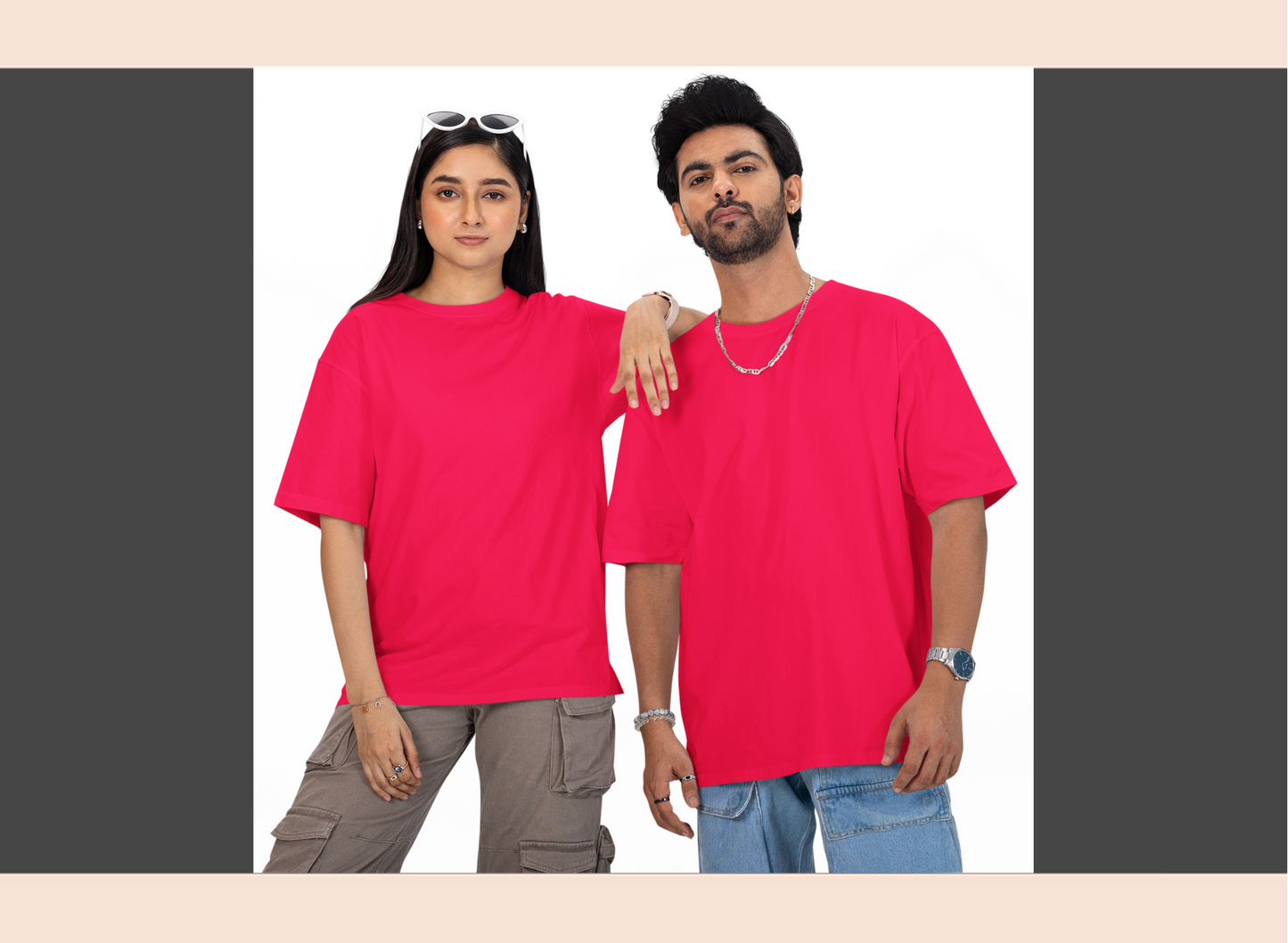 Two people wearing bright pink t-shirts standing side by side.