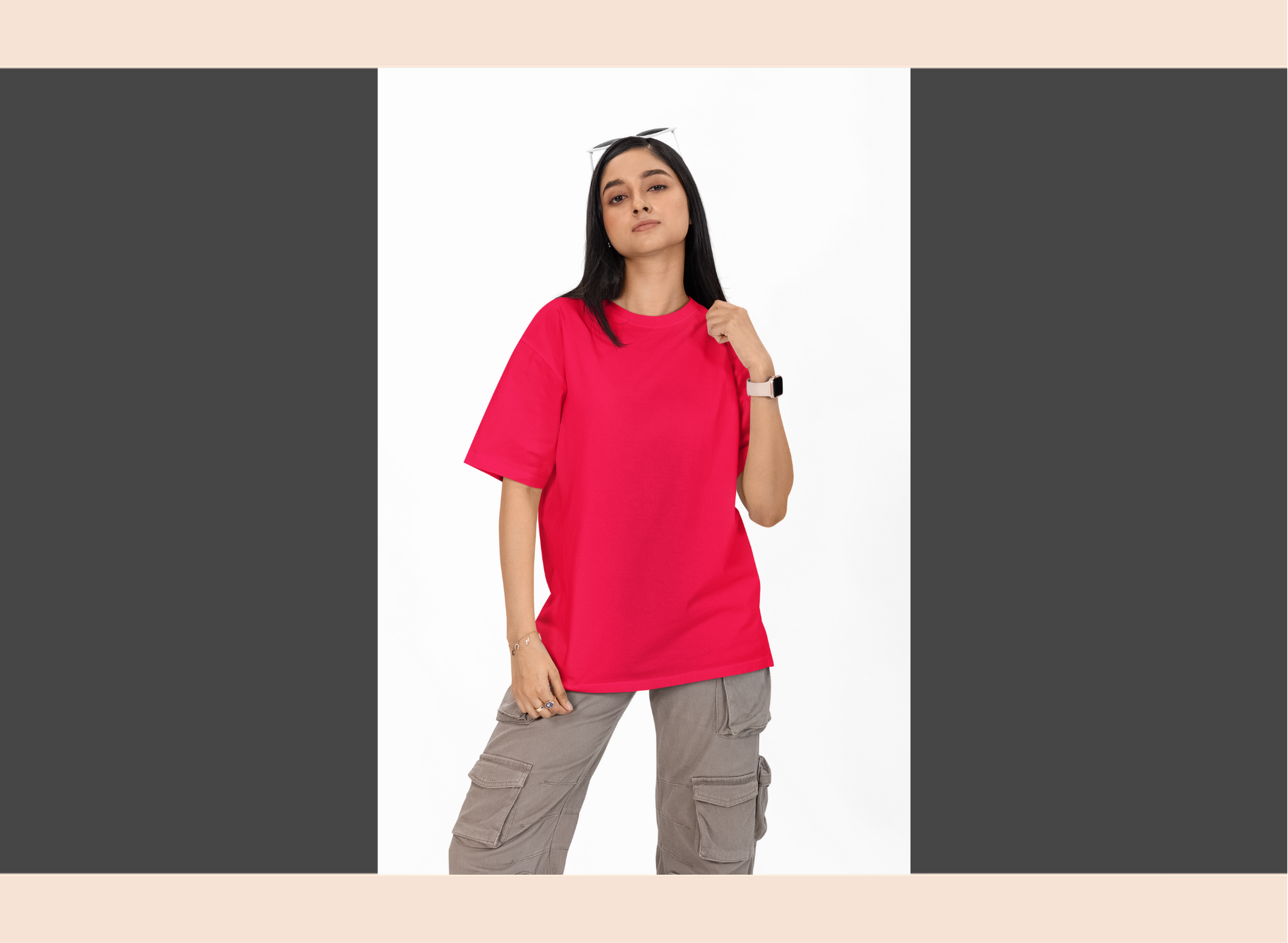 Person wearing a bright pink t-shirt and gray cargo pants on a white background