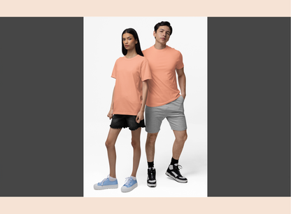 Two people wearing matching peach t-shirts on a white background