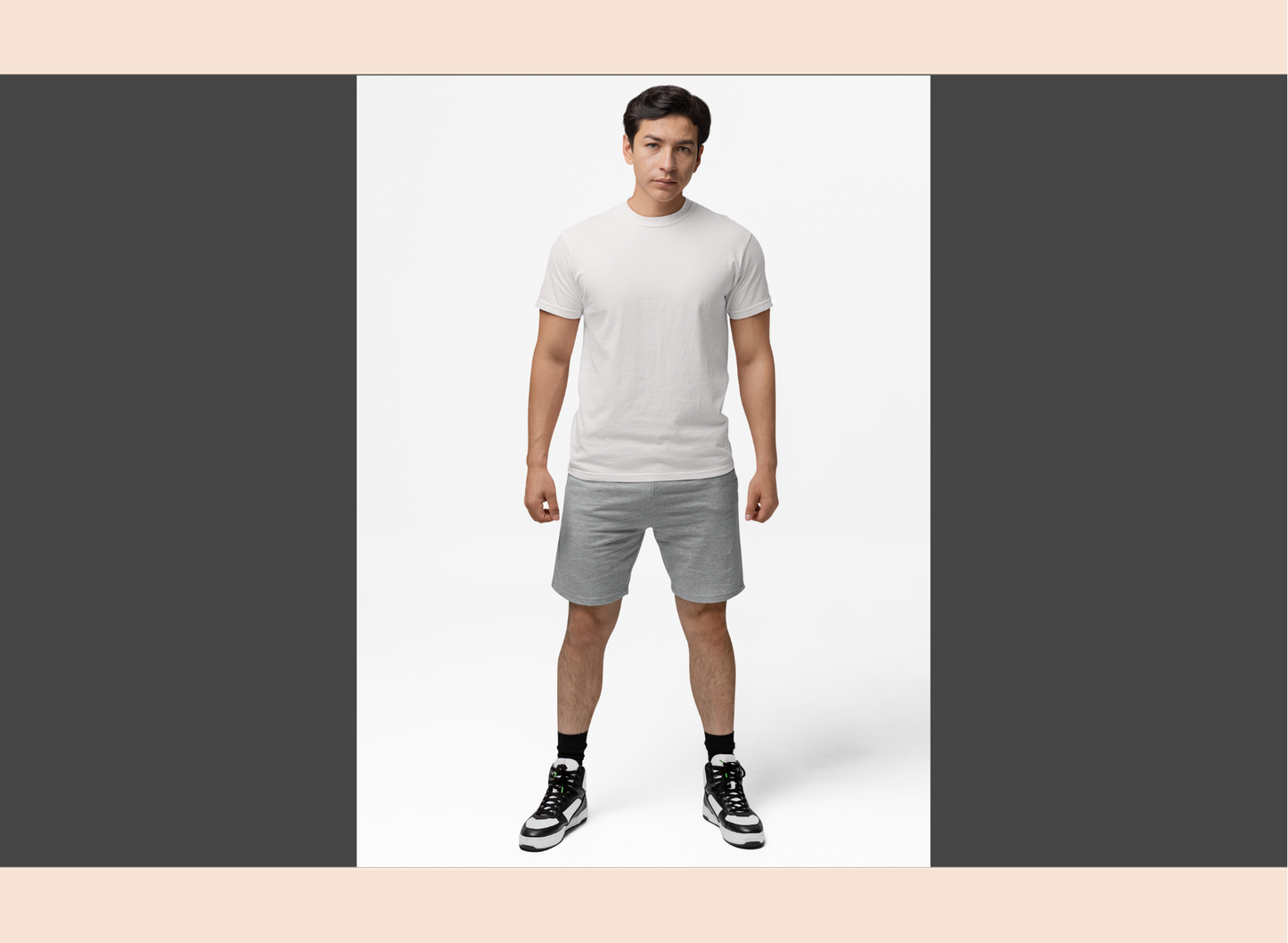 Man wearing a white t-shirt and gray shorts on a white background